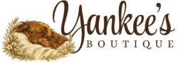 Logo for "Yankee’s Boutique" featuring a brown dog sleeping on a pillow with floral accents, alongside elegant cursive and serif lettering.