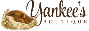 Logo for "Yankee’s Boutique" featuring a brown dog sleeping on a pillow with floral accents, alongside elegant cursive and serif lettering.